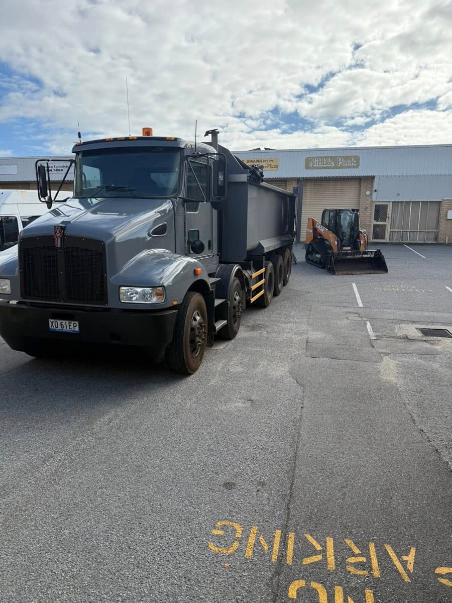 Tip truck and skidsteer at the depot